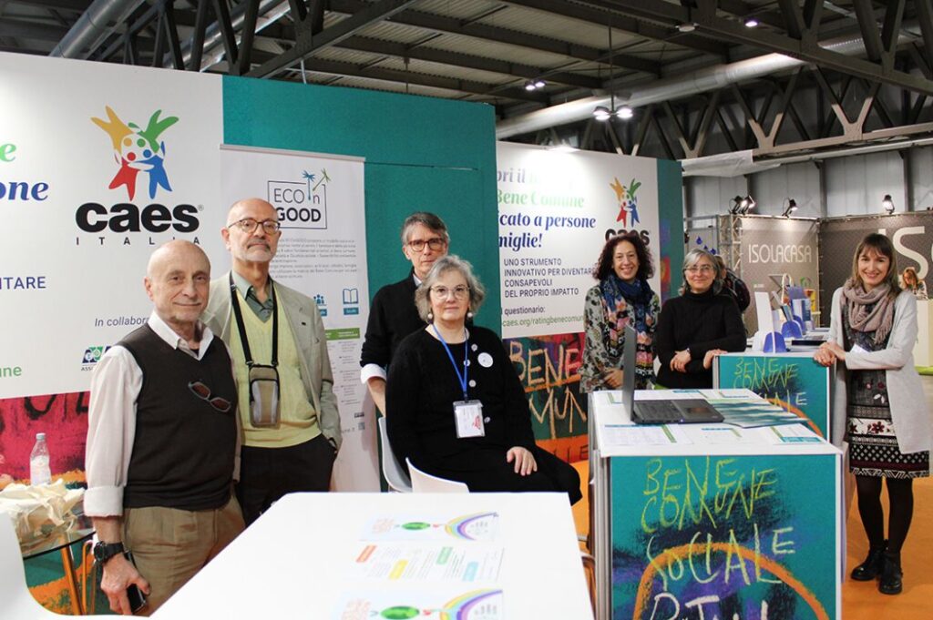 Lo staff del Consorzio CAES, promotore di un modello di assicurazione etica, insieme a Lidia Di Vece, presidente di Eco in Good Italia, durante un evento fieristico.